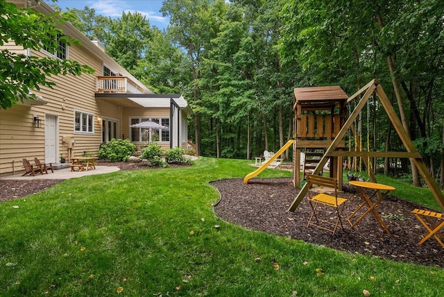 4608 Old Grand River Trl NE, Ada, MI 49301 - view of green lawn featuring a playground, a balcony, and a patio