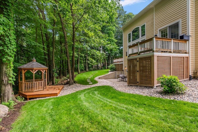 4608 Old Grand River Trl NE, Ada, MI 49301 - view of green lawn with a gazebo, a wooden deck, and a patio