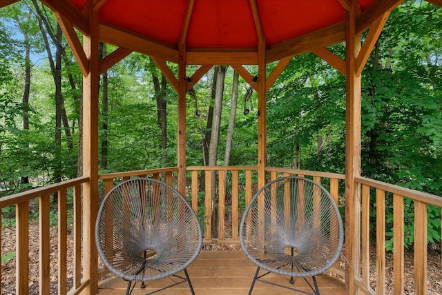 4608 Old Grand River Trl NE, Ada, MI 49301 - wooden terrace featuring a gazebo and view of wooded area