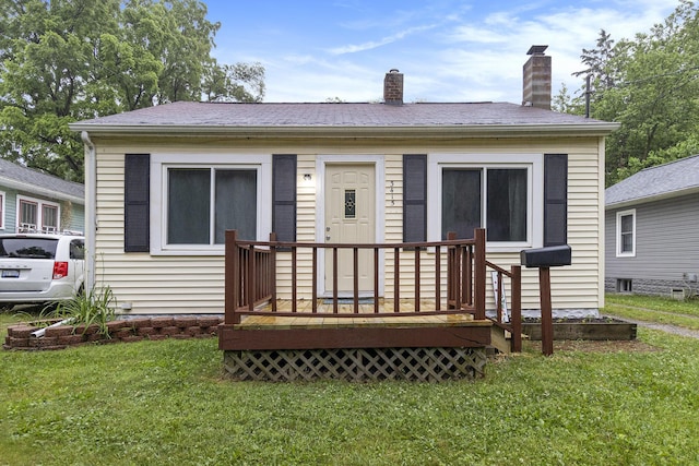 3415 Hoover St, Kalamazoo, MI 49008 - back of house with a lawn, a chimney, and a wooden deck
