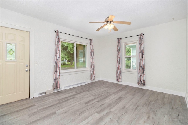 3415 Hoover St, Kalamazoo, MI 49008 - entryway featuring baseboard heating, wood finished floors, and a ceiling fan