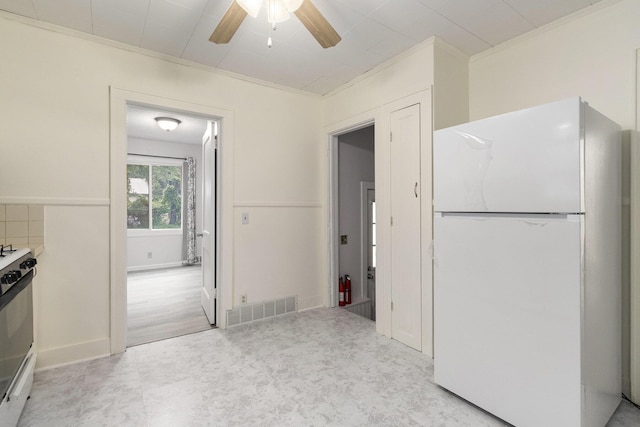 3415 Hoover St, Kalamazoo, MI 49008 - kitchen featuring freestanding refrigerator, gas stove, a ceiling fan, and ornamental molding