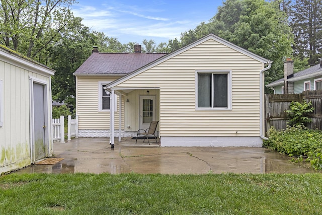 3415 Hoover St, Kalamazoo, MI 49008 - back of house featuring a patio area and a chimney