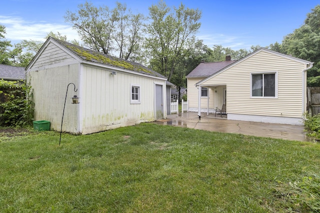3415 Hoover St, Kalamazoo, MI 49008 - rear view of property with an outdoor structure, a patio, and a shingled roof
