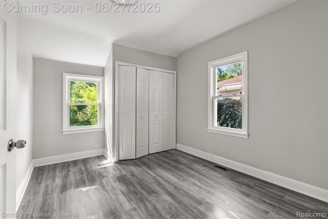 19349 Negaunee, Redford, MI 48240 - unfurnished bedroom with multiple windows, wood finished floors, and a closet