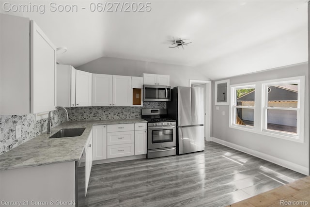 19349 Negaunee, Redford, MI 48240 - kitchen featuring appliances with stainless steel finishes, vaulted ceiling, tasteful backsplash, white cabinets, and electric panel