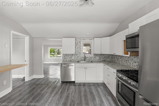 19349 Negaunee, Redford, MI 48240 - kitchen with appliances with stainless steel finishes, vaulted ceiling, white cabinets, light stone counters, and dark wood-style floors