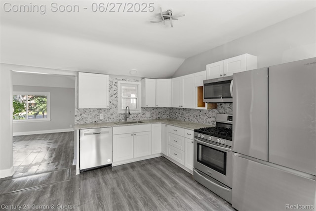 19349 Negaunee, Redford, MI 48240 - kitchen featuring stainless steel appliances, wood finished floors, lofted ceiling, white cabinets, and tasteful backsplash