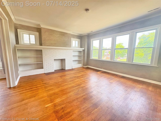 2135 Lakewood, Detroit, MI 48215 - unfurnished living room featuring wood-type flooring, healthy amount of natural light, and built in shelves