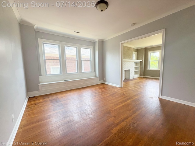 2135 Lakewood, Detroit, MI 48215 - unfurnished living room featuring wood finished floors and ornamental molding