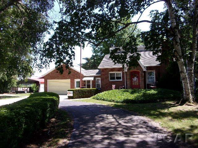 9981 W Mulberry Rd, Morenci, MI 49256 - view of front facade featuring asphalt driveway, brick siding, and an attached garage