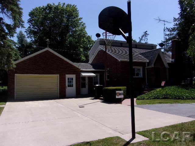 9981 W Mulberry Rd, Morenci, MI 49256 - view of front of home with brick siding, concrete driveway, and a garage