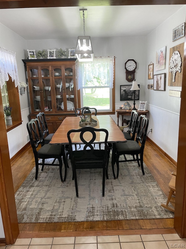 9981 W Mulberry Rd, Morenci, MI 49256 - dining area with wood finished floors and a wainscoted wall
