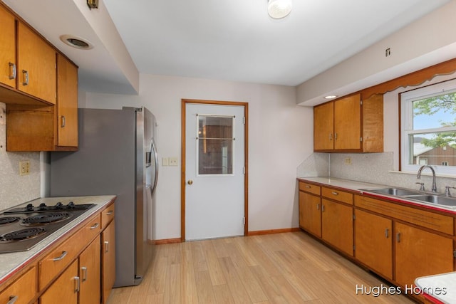 7970 Burlingame Ave SW, Byron Center, MI 49315 - kitchen with electric stovetop, brown cabinets, light countertops, and light wood-style flooring