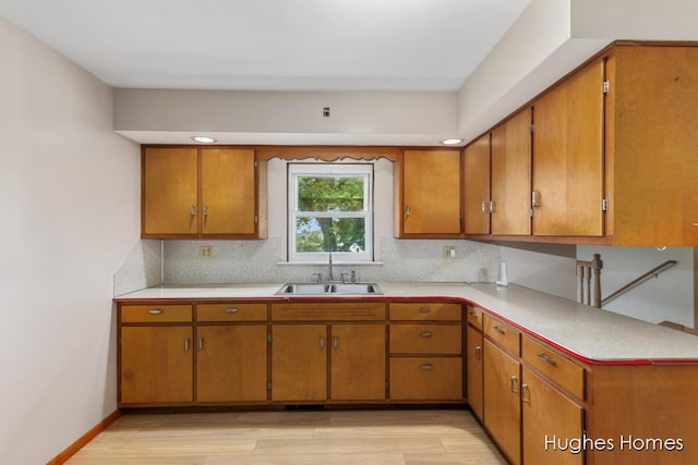 7970 Burlingame Ave SW, Byron Center, MI 49315 - kitchen with light countertops, light wood-style flooring, and brown cabinetry