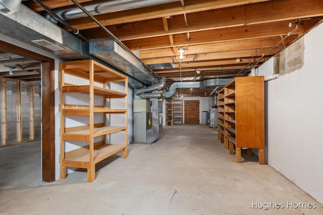 7970 Burlingame Ave SW, Byron Center, MI 49315 - unfinished basement featuring water heater and heating unit