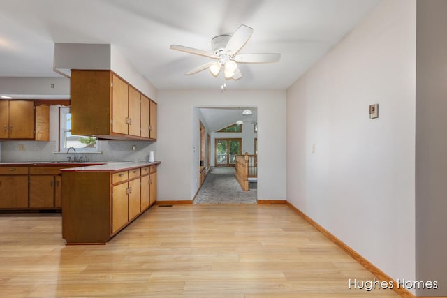 7970 Burlingame Ave SW, Byron Center, MI 49315 - kitchen featuring a ceiling fan, healthy amount of natural light, light wood-style floors, and tasteful backsplash