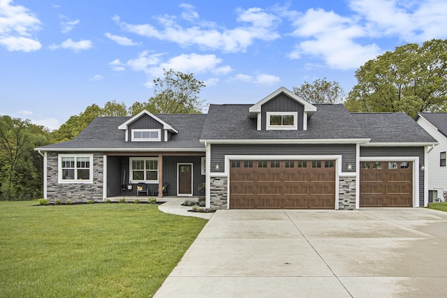 10924 Mystic Heights Trl, Michigan, MI 49071 - craftsman house featuring stone siding, a porch, driveway, and a front lawn