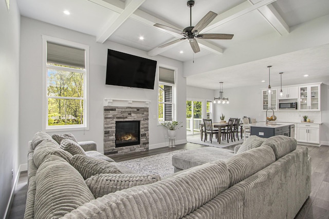 10924 Mystic Heights Trl, Michigan, MI 49071 - living area featuring dark wood-style flooring, a ceiling fan, recessed lighting, beam ceiling, and a fireplace