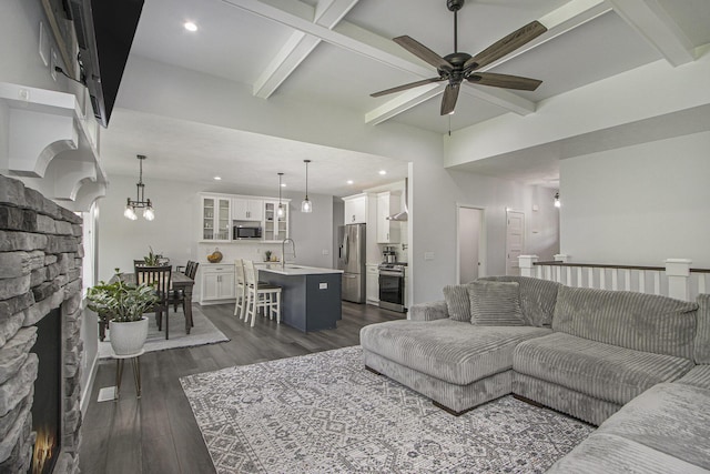 10924 Mystic Heights Trl, Michigan, MI 49071 - living room featuring dark wood-style floors, ceiling fan, beam ceiling, recessed lighting, and a chandelier
