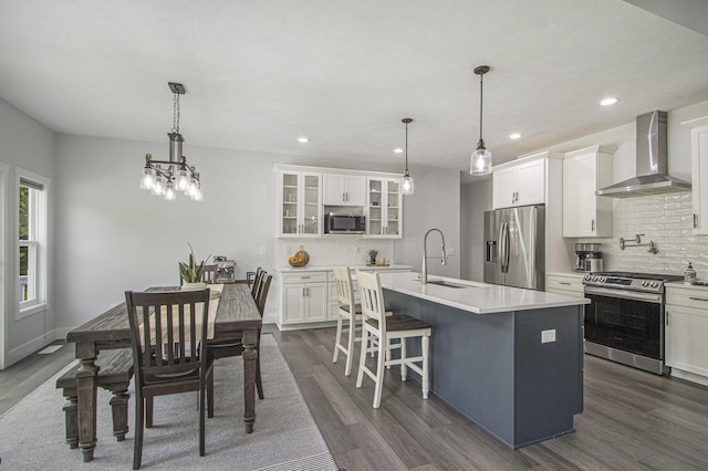 10924 Mystic Heights Trl, Michigan, MI 49071 - kitchen featuring wall chimney exhaust hood, stainless steel appliances, decorative backsplash, dark wood finished floors, and recessed lighting