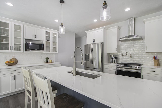 10924 Mystic Heights Trl, Michigan, MI 49071 - kitchen featuring appliances with stainless steel finishes, wall chimney exhaust hood, backsplash, glass insert cabinets, and white cabinets