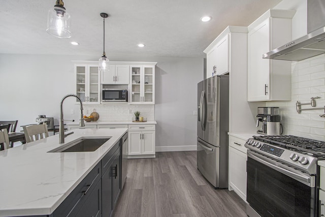 10924 Mystic Heights Trl, Michigan, MI 49071 - kitchen with stainless steel appliances, wall chimney range hood, decorative backsplash, white cabinetry, and recessed lighting