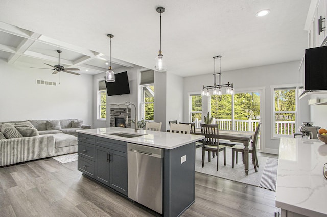 10924 Mystic Heights Trl, Michigan, MI 49071 - kitchen featuring dishwasher, dark wood-style floors, ceiling fan, a stone fireplace, and beam ceiling