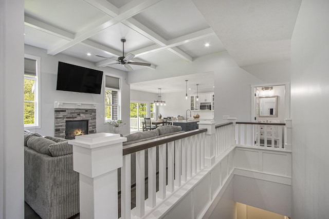 10924 Mystic Heights Trl, Michigan, MI 49071 - living room featuring ceiling fan, a stone fireplace, coffered ceiling, and beam ceiling