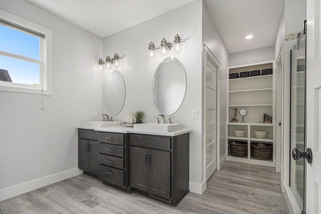 10924 Mystic Heights Trl, Michigan, MI 49071 - full bathroom featuring double vanity, wood finished floors, a spacious closet, and recessed lighting