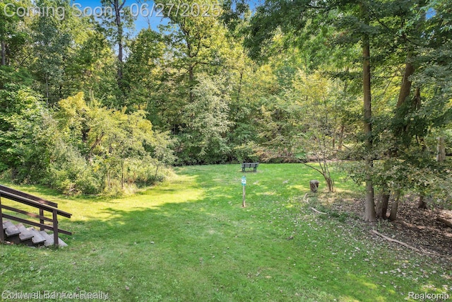 30715 River Crossing St, Bingham Farms, MI 48025 - view of grassy yard with a wooded view