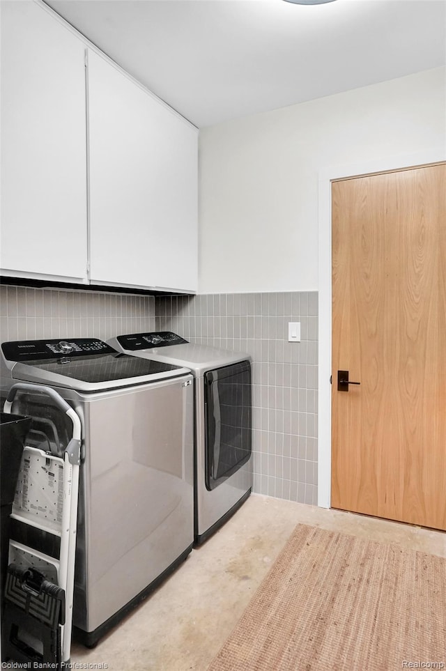 30715 River Crossing St, Bingham Farms, MI 48025 - washroom featuring cabinet space, washer and clothes dryer, tile walls, and a wainscoted wall