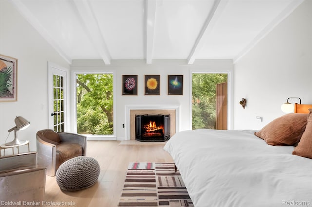 30715 River Crossing St, Bingham Farms, MI 48025 - bedroom featuring a fireplace with flush hearth, wood finished floors, and access to outside