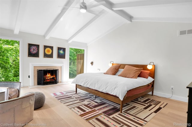 30715 River Crossing St, Bingham Farms, MI 48025 - bedroom with multiple windows, a warm lit fireplace, light wood finished floors, and access to outside