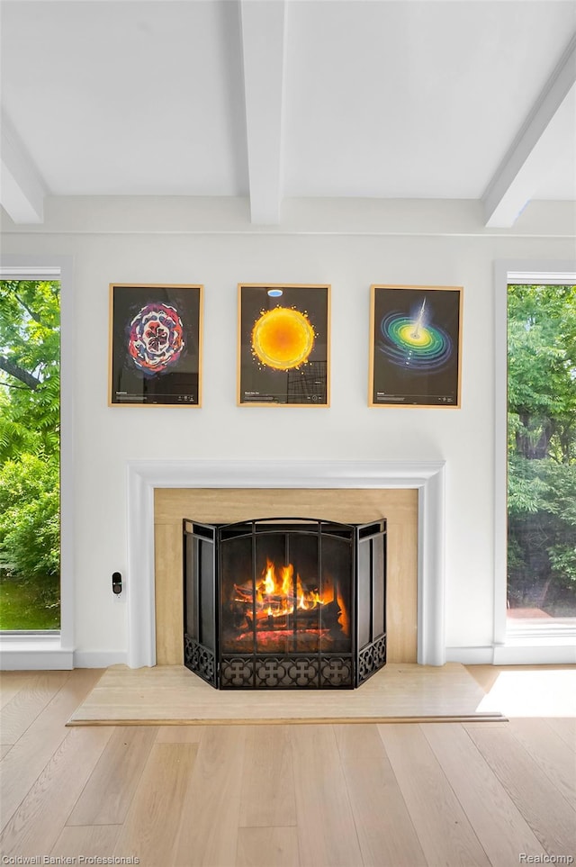 30715 River Crossing St, Bingham Farms, MI 48025 - detailed view of beamed ceiling, a lit fireplace, and wood finished floors