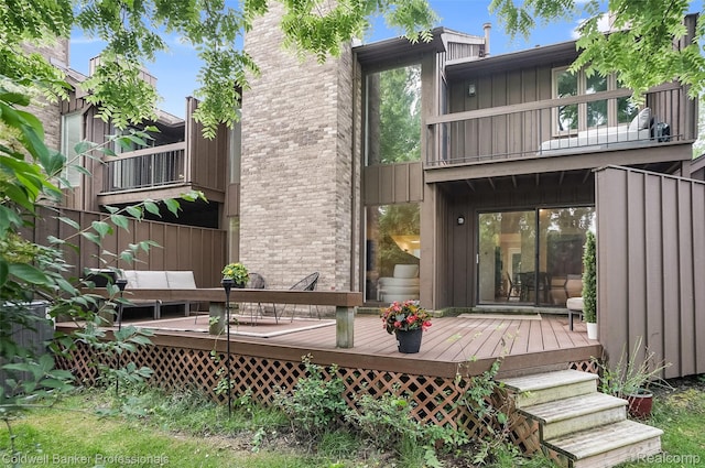 30715 River Crossing St, Bingham Farms, MI 48025 - back of house with a balcony, board and batten siding, a wooden deck, and brick siding