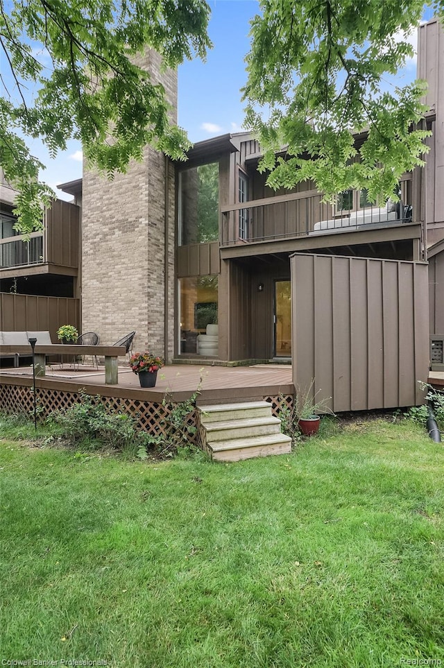 30715 River Crossing St, Bingham Farms, MI 48025 - rear view of house featuring a balcony, a lawn, board and batten siding, and a deck