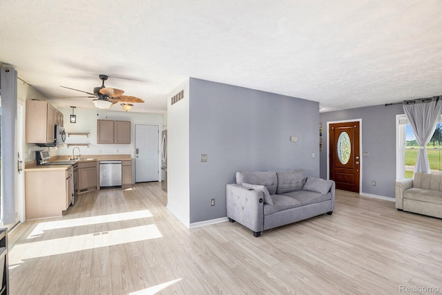 11632 Glen Mary Dr, Byron, MI 48418 - living area featuring light wood-type flooring, ceiling fan, and a textured ceiling