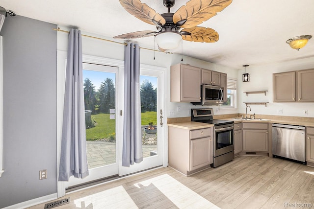 11632 Glen Mary Dr, Byron, MI 48418 - kitchen featuring appliances with stainless steel finishes, a ceiling fan, light wood-style flooring, light countertops, and gray cabinetry