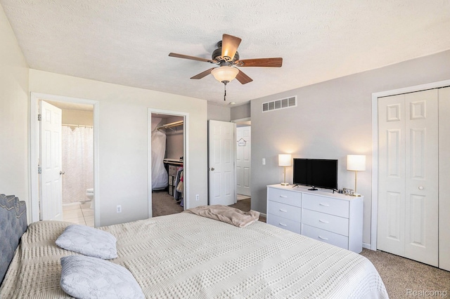 11632 Glen Mary Dr, Byron, MI 48418 - bedroom featuring light carpet, ensuite bathroom, ceiling fan, and a spacious closet