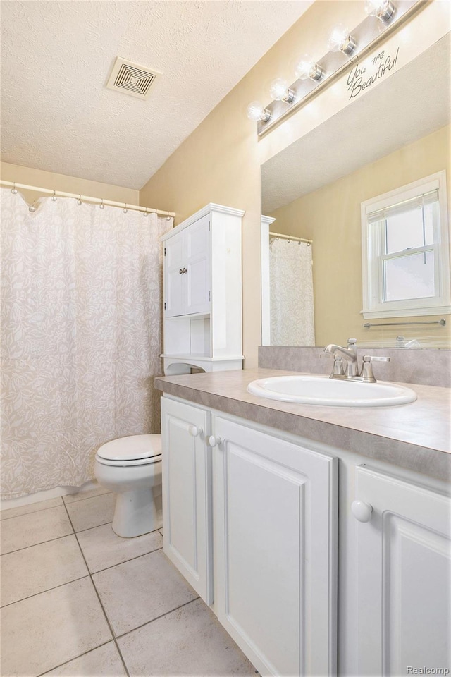 11632 Glen Mary Dr, Byron, MI 48418 - full bathroom with vanity, tile patterned flooring, and a textured ceiling