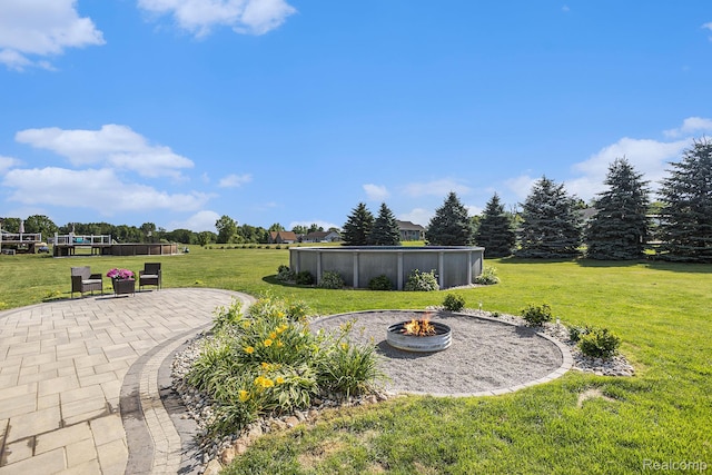 11632 Glen Mary Dr, Byron, MI 48418 - view of green lawn with an outdoor fire pit, an outdoor pool, and a patio