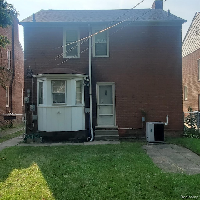 18918 Hartwell, Detroit, MI 48235 - back of house featuring entry steps, brick siding, a chimney, and a shingled roof