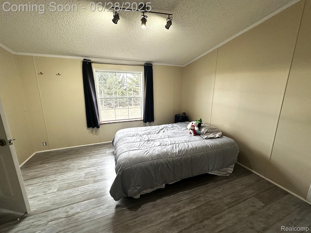 2652 Murphy Lake Rd, Silverwood, MI 48760 - bedroom featuring a textured ceiling, wood finished floors, crown molding, and vaulted ceiling