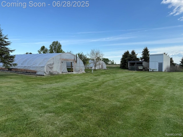 2652 Murphy Lake Rd, Silverwood, MI 48760 - view of green lawn with an outbuilding and an exterior structure