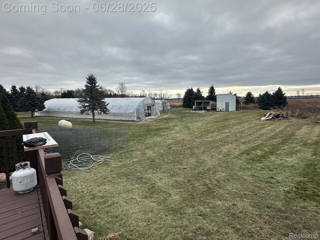 2652 Murphy Lake Rd, Silverwood, MI 48760 - view of grassy yard featuring a greenhouse and an outbuilding