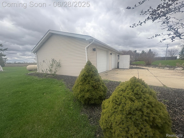 2652 Murphy Lake Rd, Silverwood, MI 48760 - view of home's exterior with a lawn, a garage, and an outbuilding
