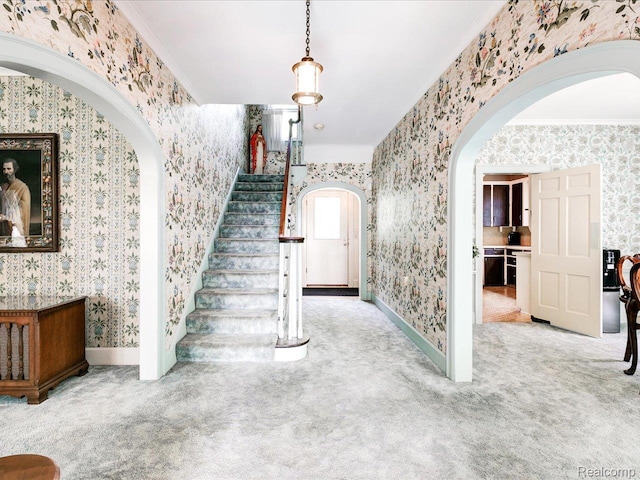 2815 Military St, Fort Gratiot, MI 48060 - staircase featuring arched walkways, wallpapered walls, carpet, and ornamental molding