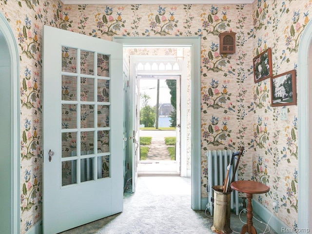 2815 Military St, Fort Gratiot, MI 48060 - entryway featuring wallpapered walls, arched walkways, carpet flooring, and radiator