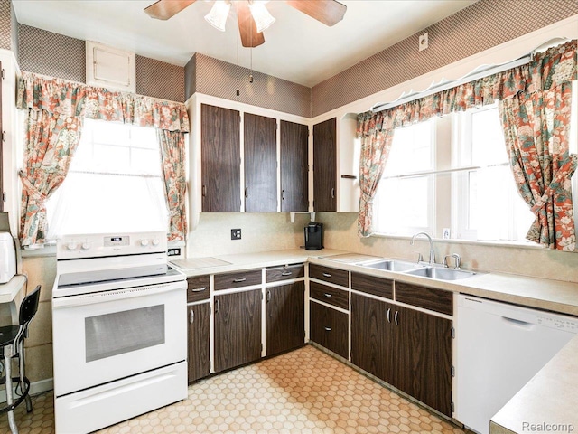 2815 Military St, Fort Gratiot, MI 48060 - kitchen featuring white appliances, dark brown cabinetry, light countertops, and light floors